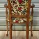 Convertible armchair with brocade fabric and floral patterns.