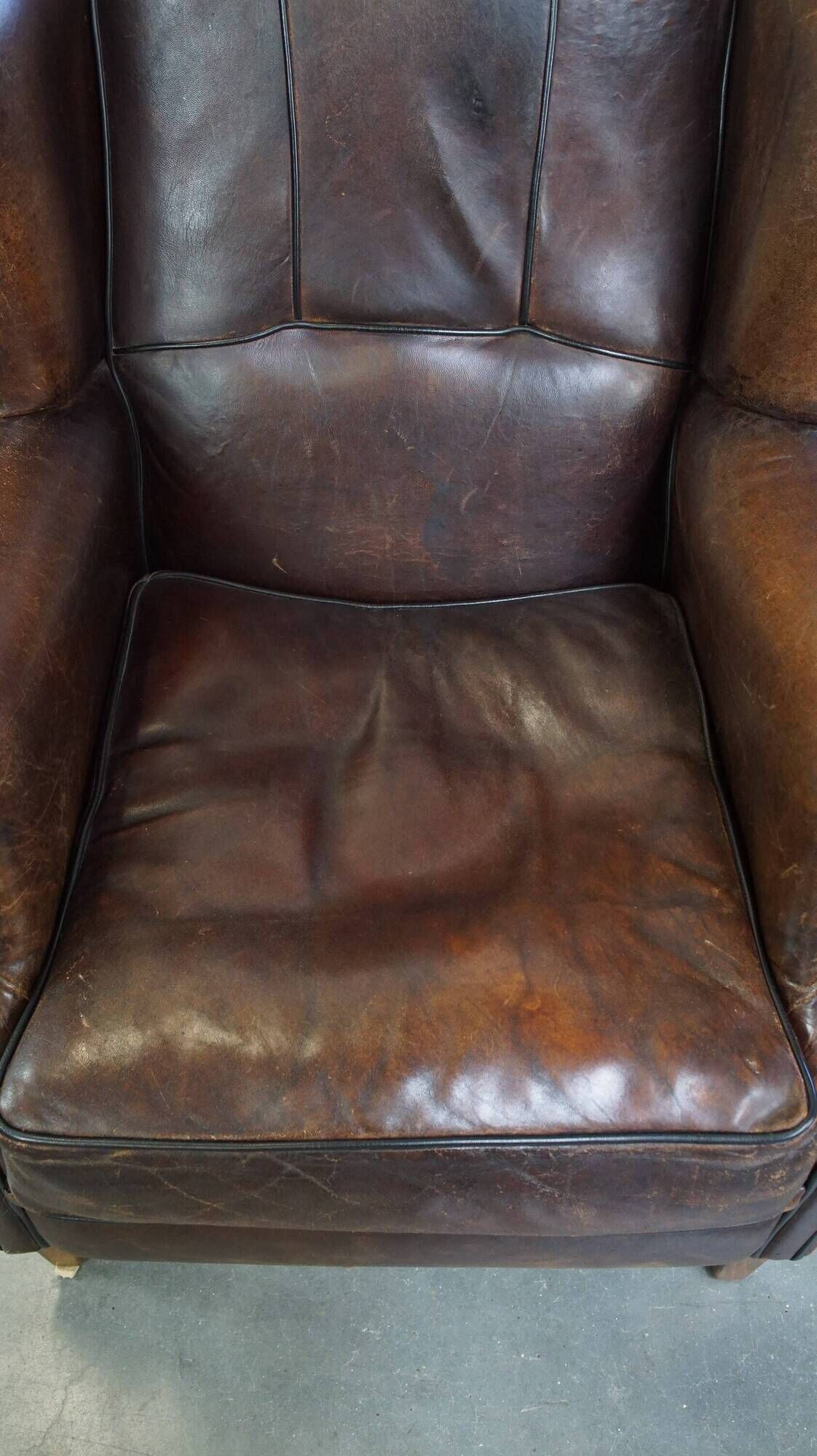 Wing chair made of sheepskin and neatly finished with black piping