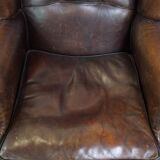 Wing chair made of sheepskin and neatly finished with black piping