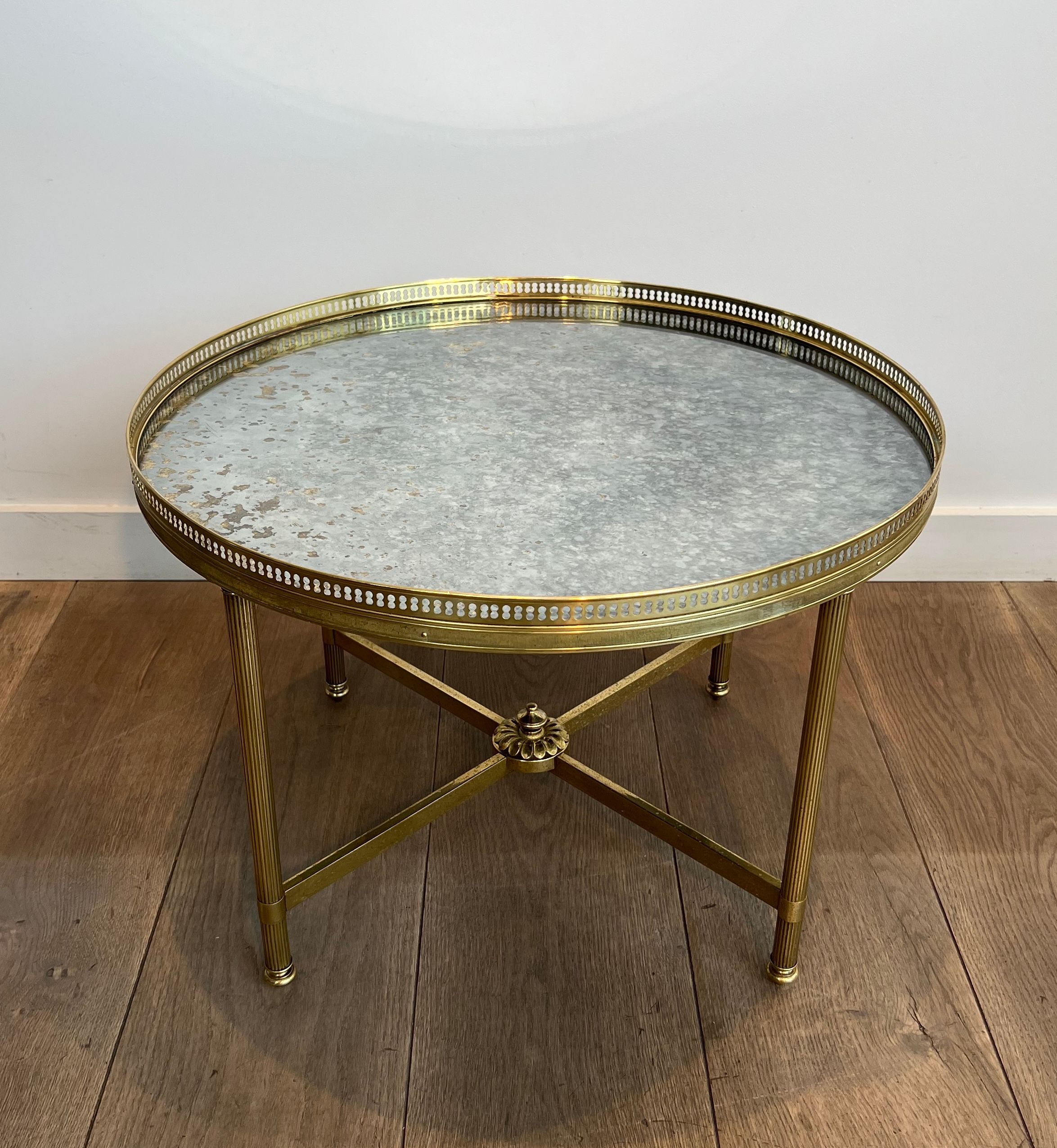 Brass coffee table with a vintage mirror top from the Baguès house.