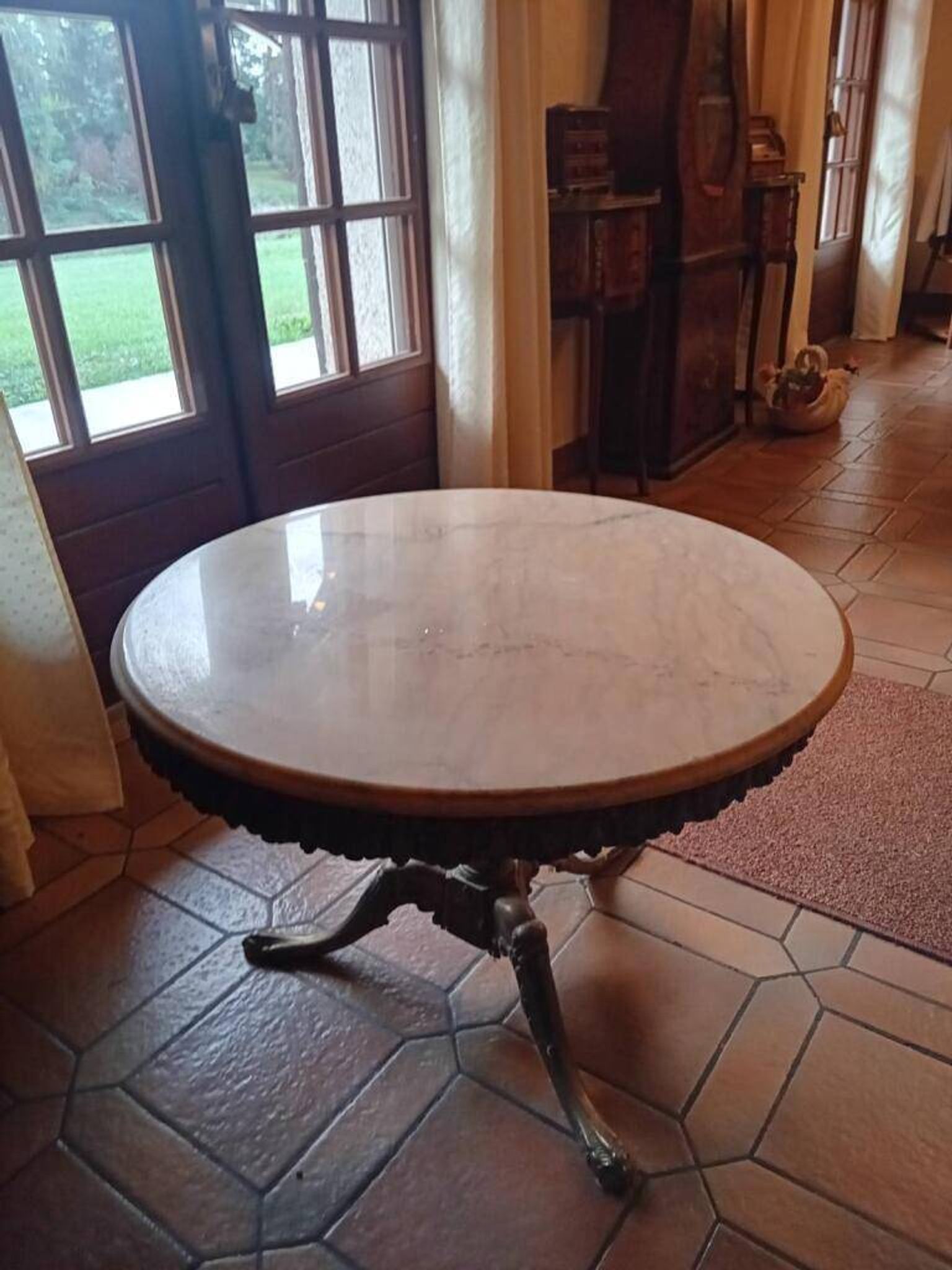 Round coffee table with a brass frame.