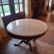 Round coffee table with a brass frame.