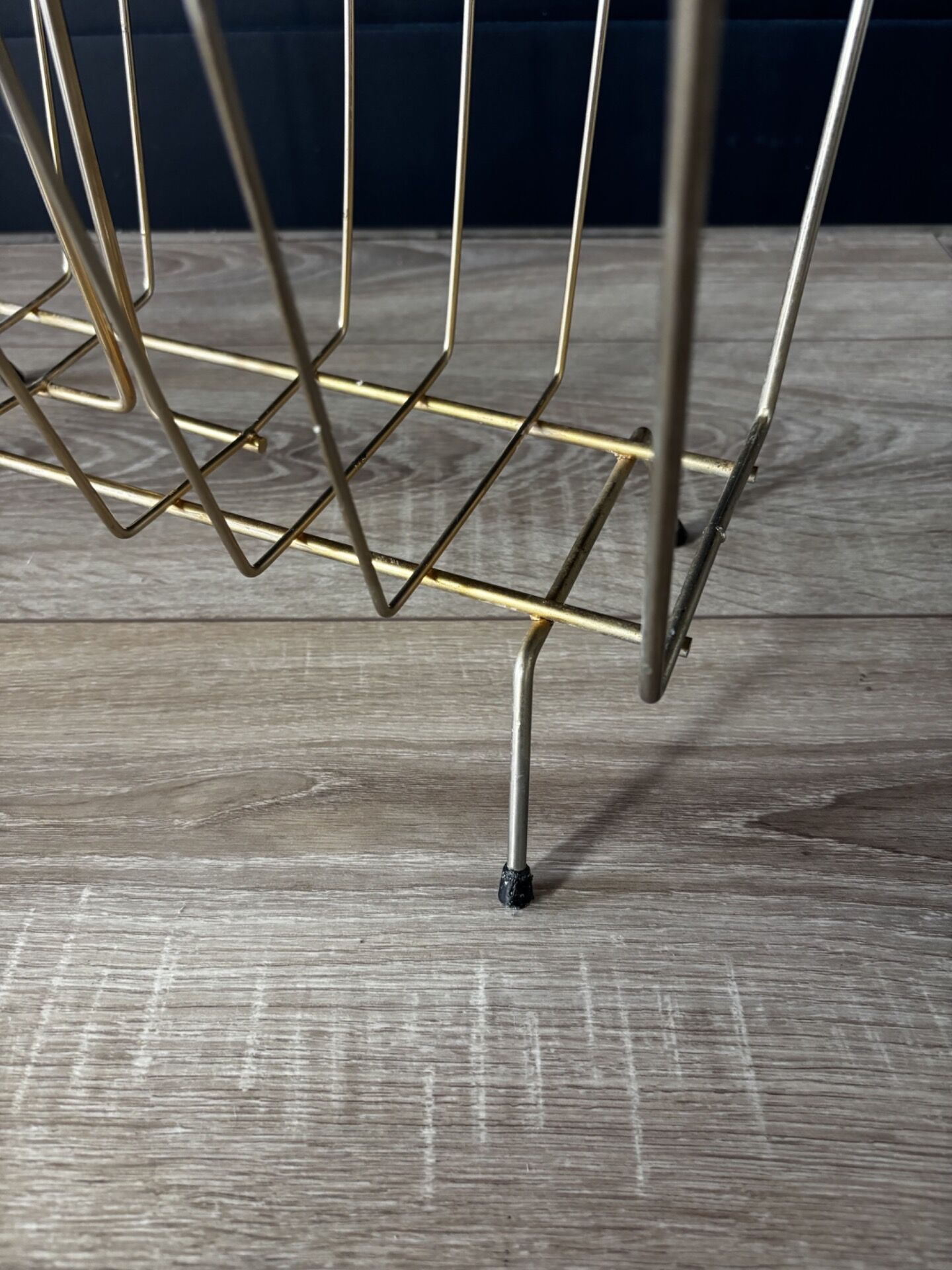 Mid-century magazine rack in golden metal wire