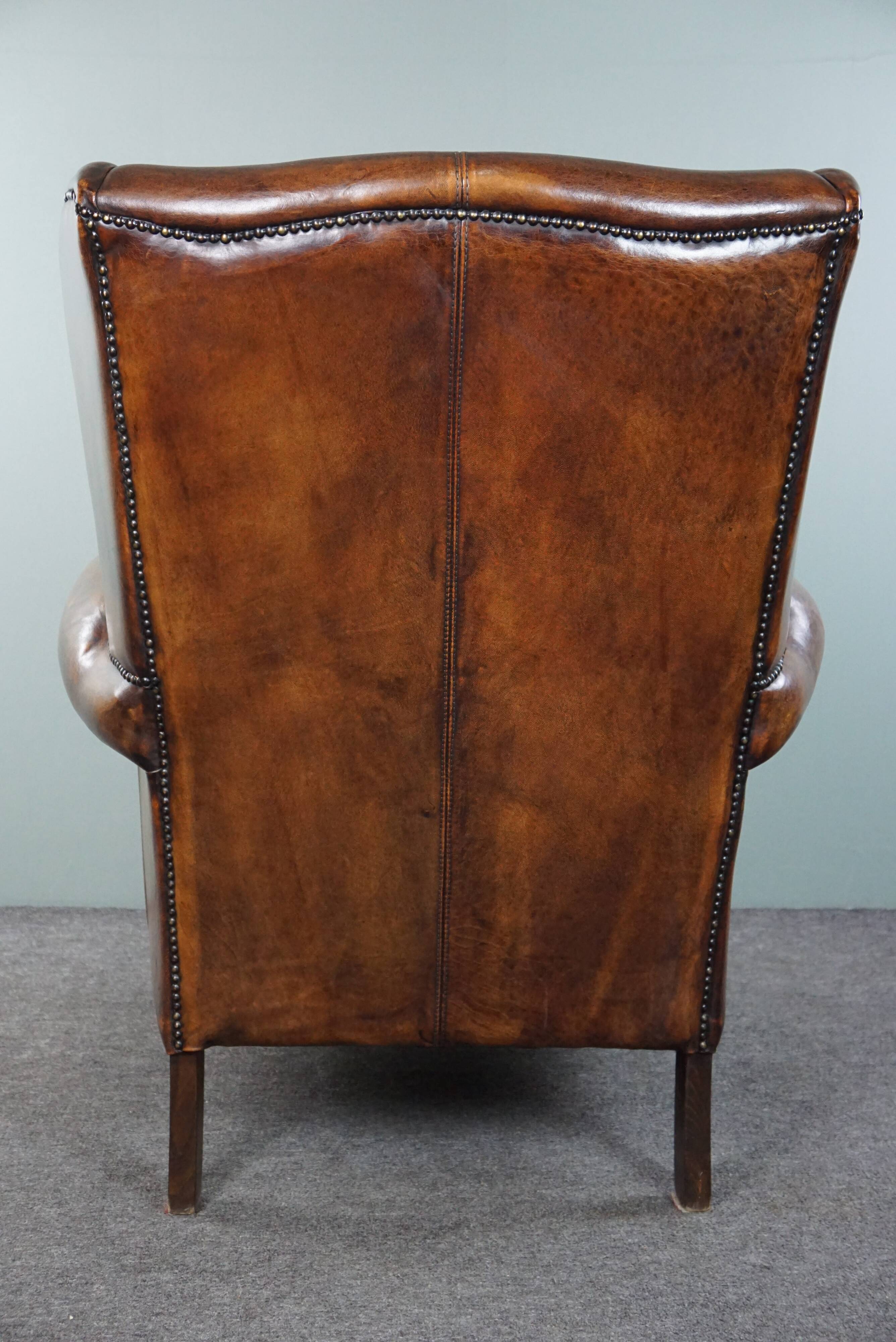 Dark wingback armchair made of sheep leather with stunning colors