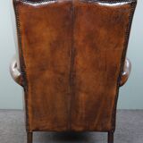 Dark wingback armchair made of sheep leather with stunning colors