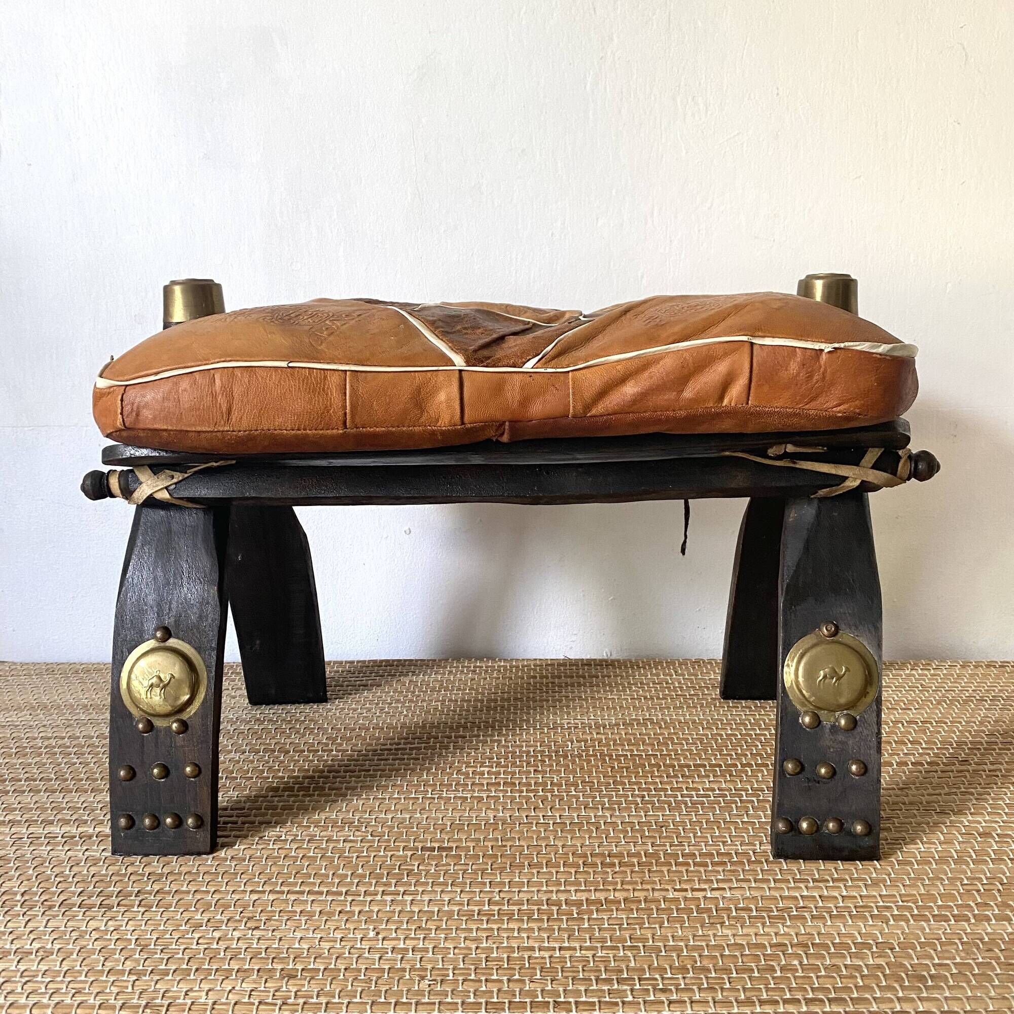 Pair of low Egyptian stools, camel saddles in wood, leather and brass