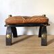 Pair of low Egyptian stools, camel saddles in wood, leather and brass