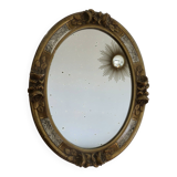 Oval wall mirror, golden floral pattern in stucco and wood, late 19th century