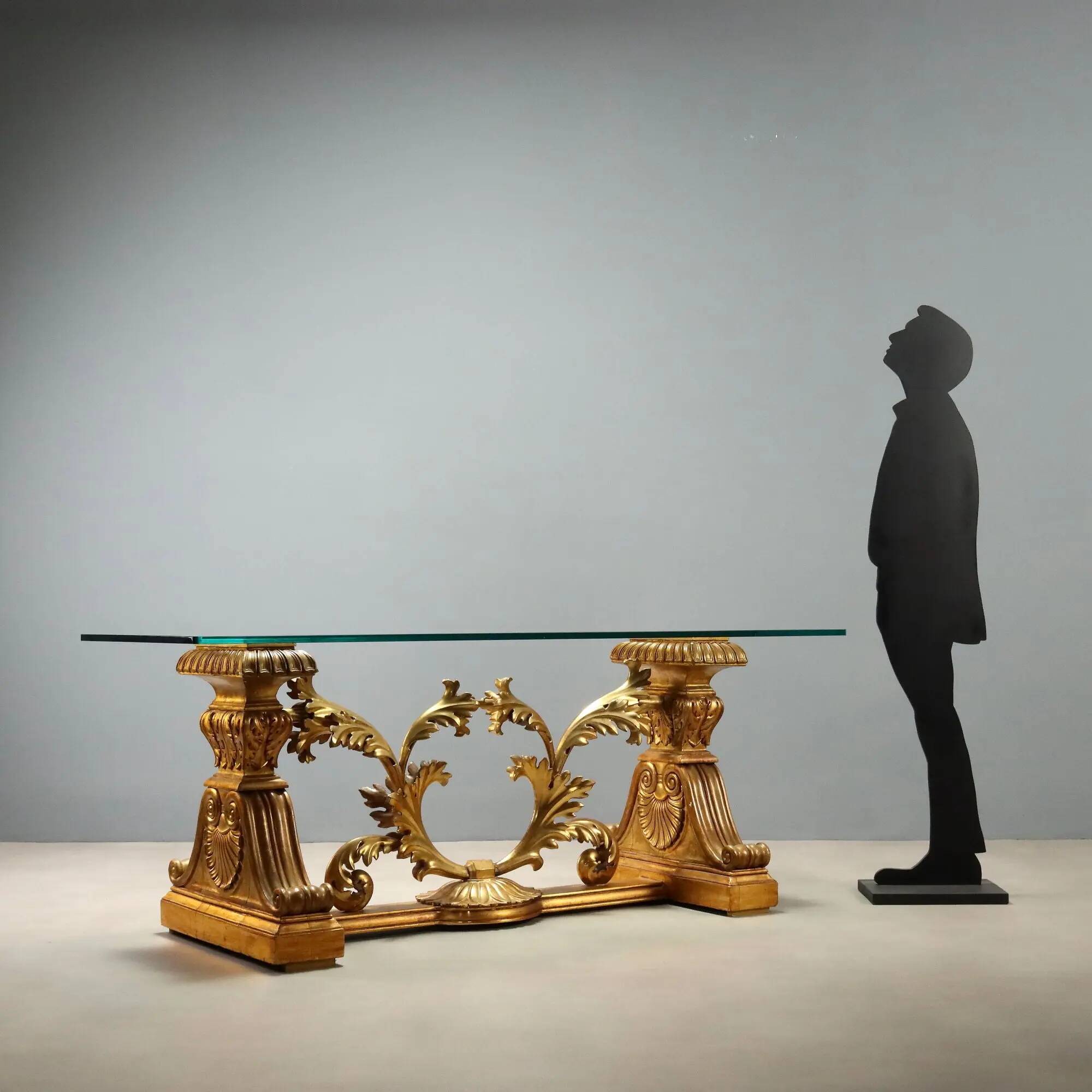 Antique coffee table in gilded wood with a glass top, Italy, 20th century.