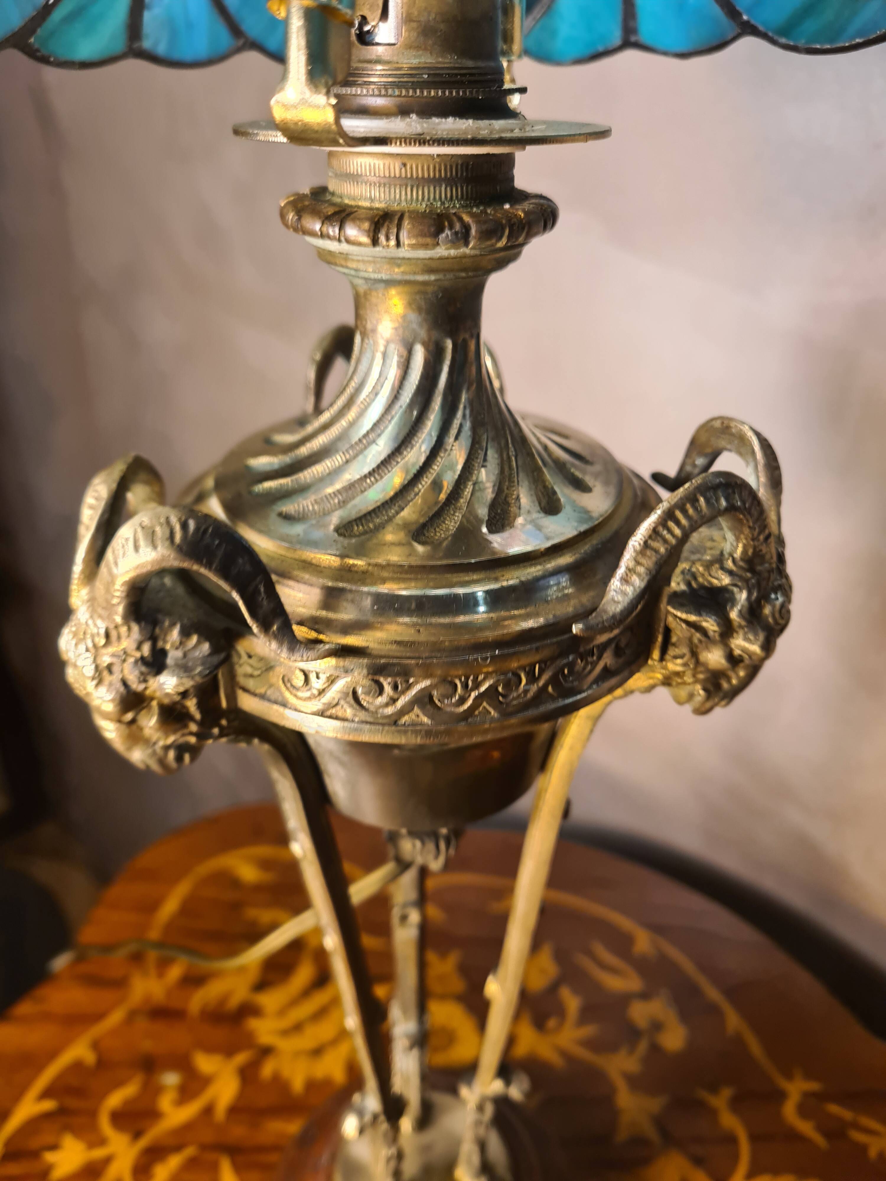 bronze lamp with a goat's head from the 19th century and a stained glass lampshade soldered with lead
