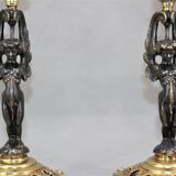Pair of candle holders in gilded bronze and patinated with a candle