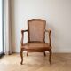 Low Louis XV armchair in wood and cane