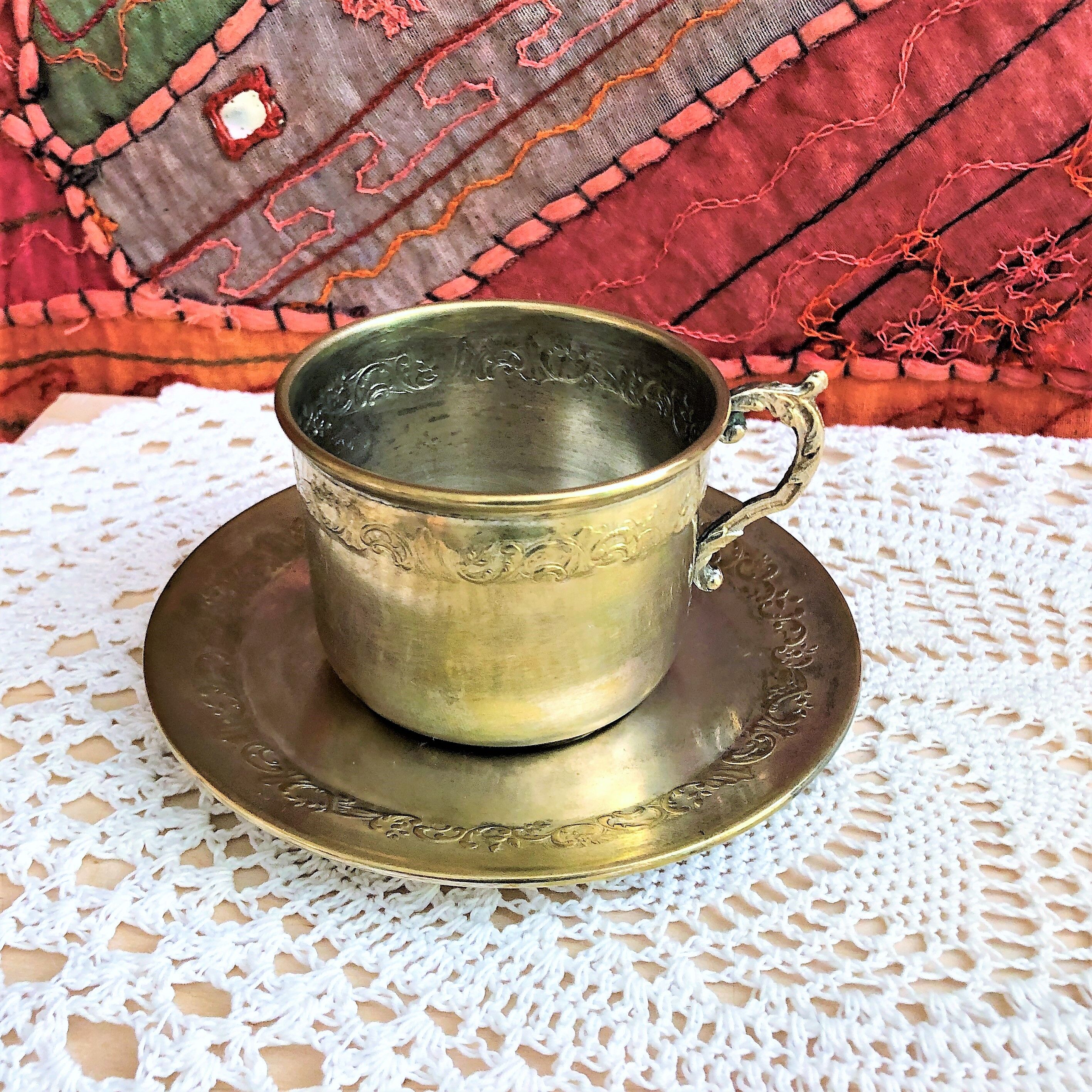 Silver metal cup and saucer