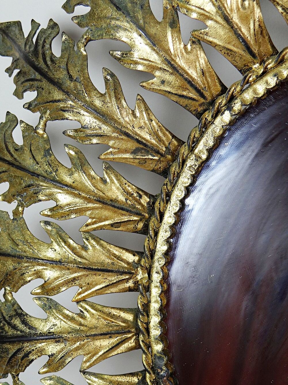 Large Italian sunburst wall mirror in gilded metal, 1960s-70s.