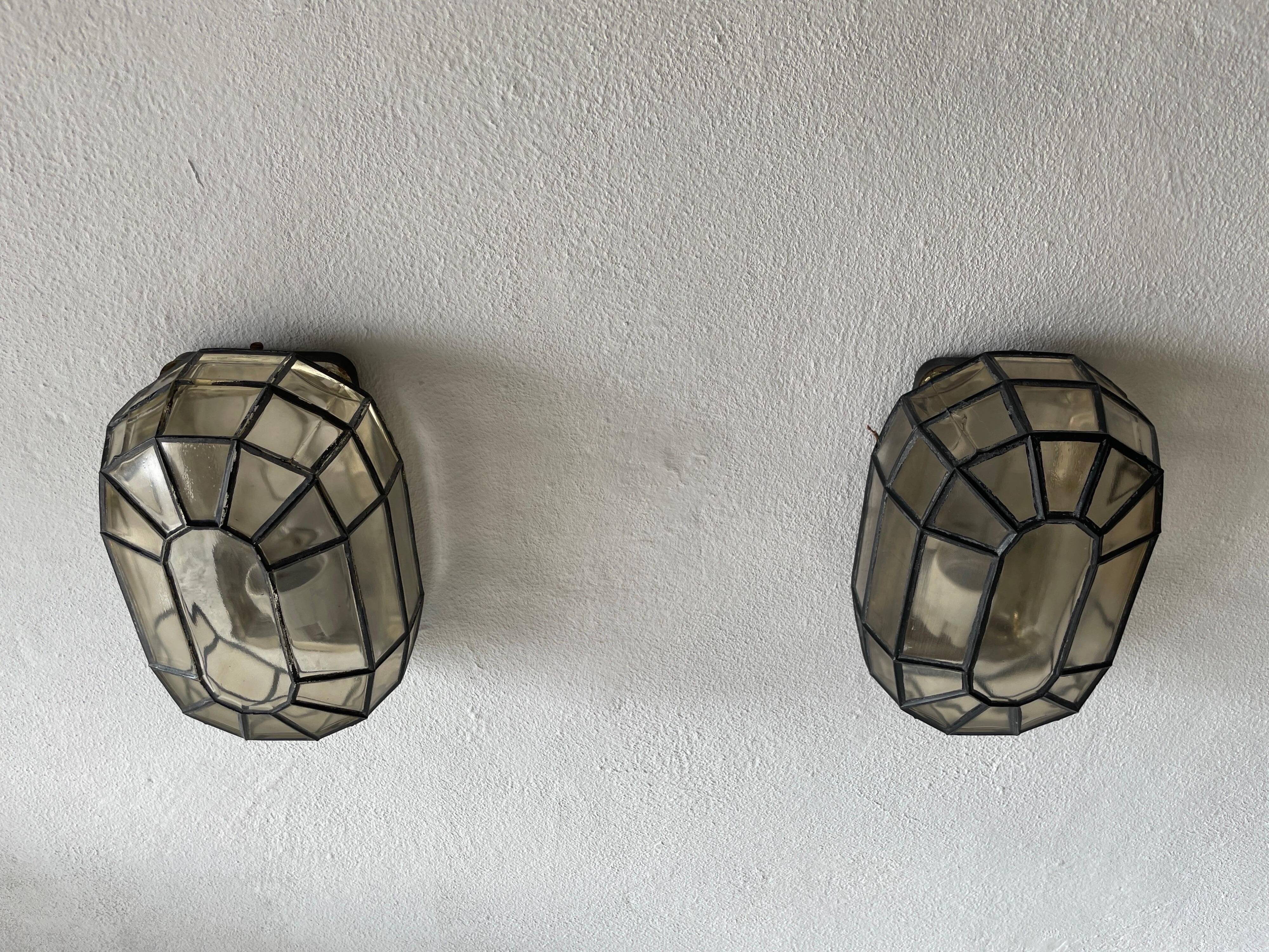 Pair of black iron wall sconces with structured glass by Limburg, 1960s, Germany.