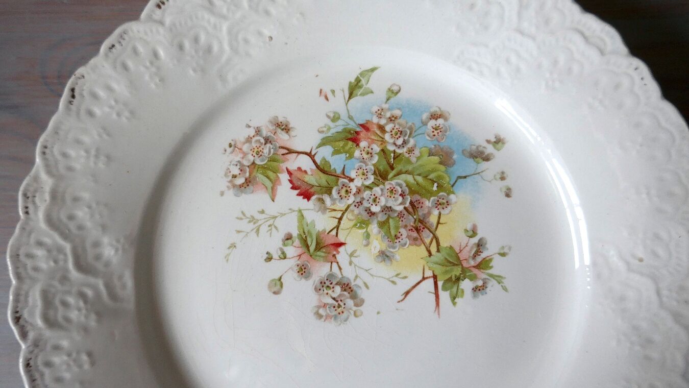 Antique earthenware plate with cherry blossom decoration