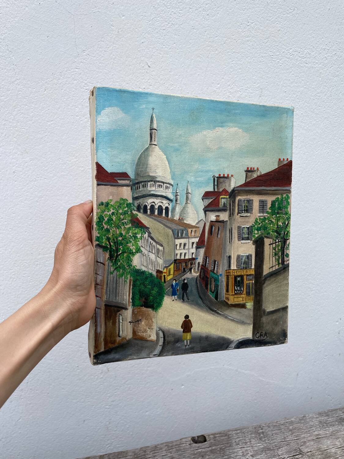 Old oil painting depicting a street in Montmartre