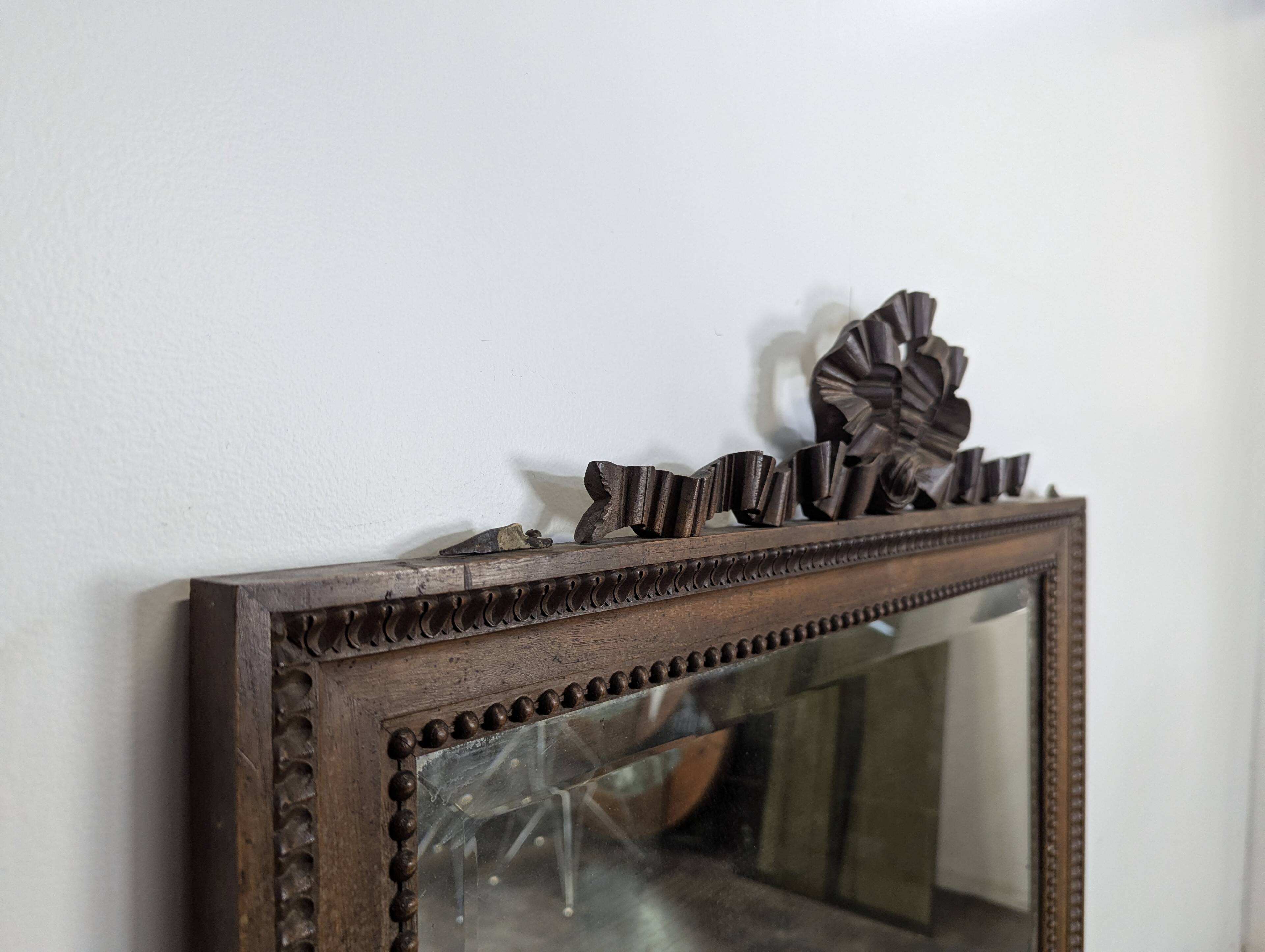 Louis XVI style mirror in carved walnut.