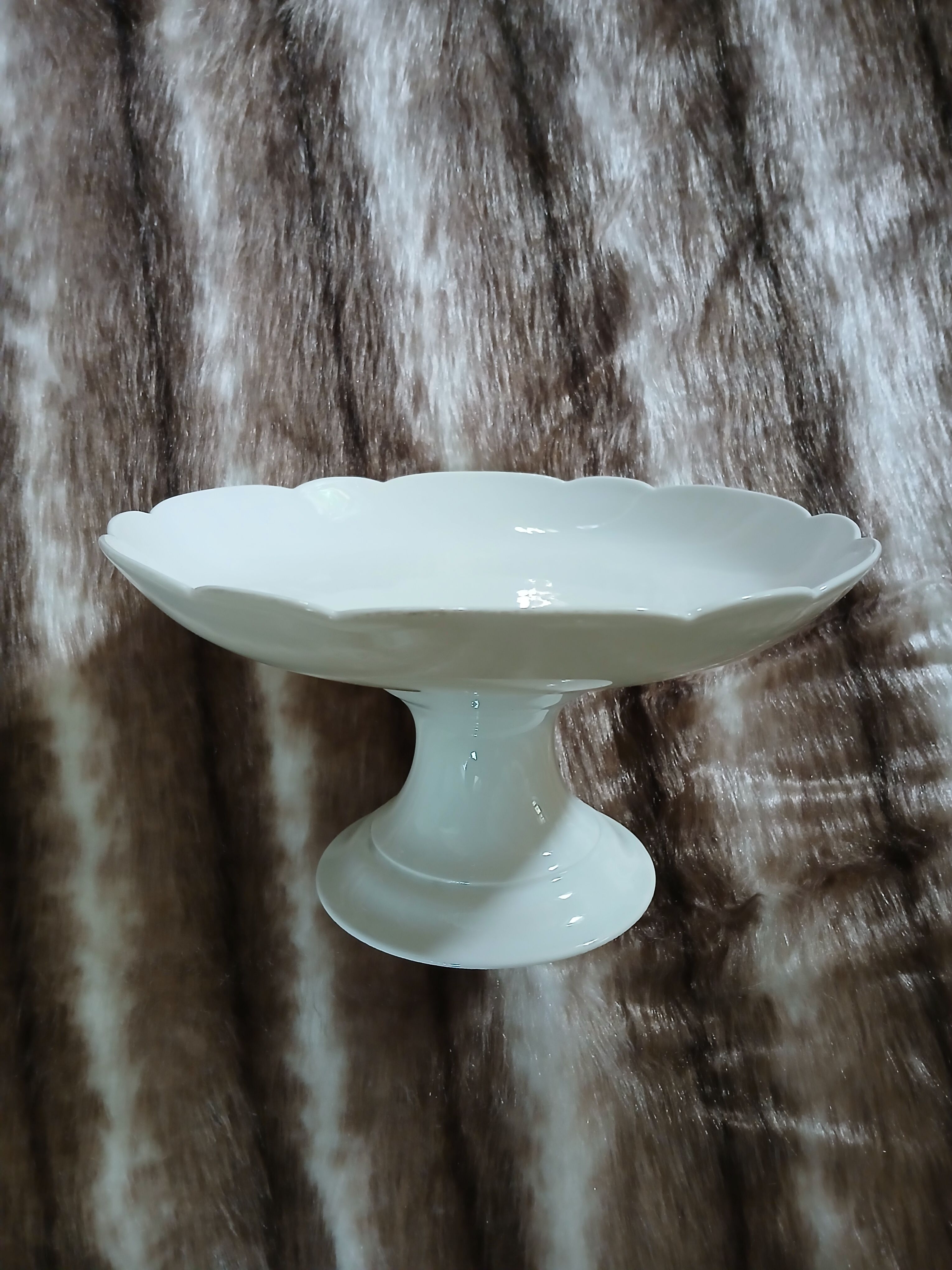 White compote dish with scalloped edges