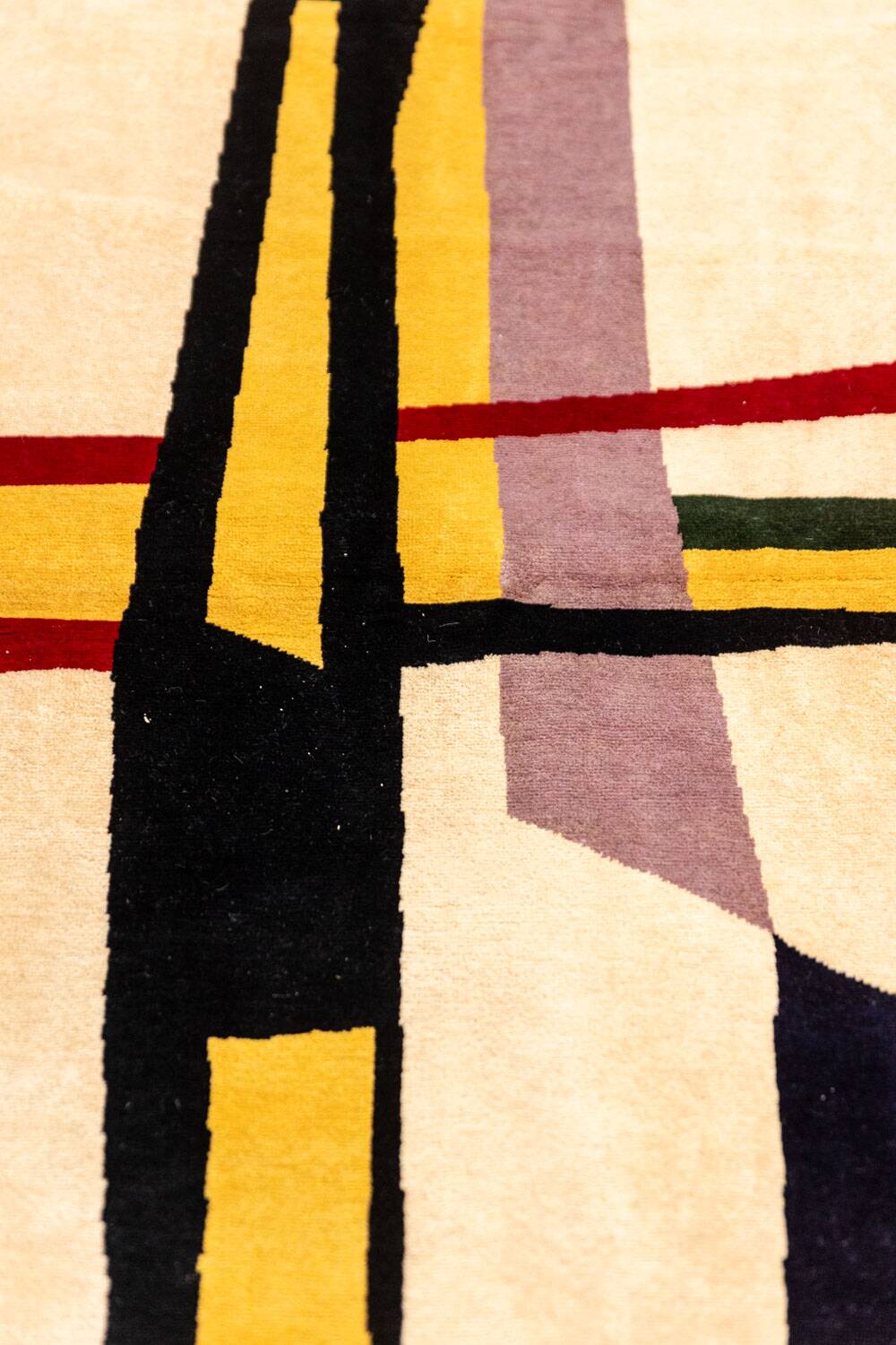 Handwoven wool tapestry with colourful geometric design. 2026.