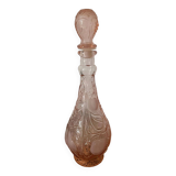 Pink glass carafe with frosted and embossed fruit patterns.