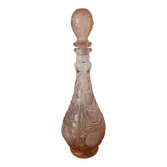 Pink glass carafe with frosted and embossed fruit patterns.
