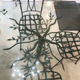 Wrought iron table with tree sculpture and glass top