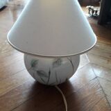 Antique ceramic lamp with a floral design.