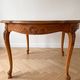 Round Louis XV dining table in solid cherry wood.