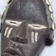Tribal Dan mask in wood and cowrie shells, West Africa, 27 cm