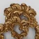 French Rococo or Baroque style facet-cut crest mirror in gilded carved wood