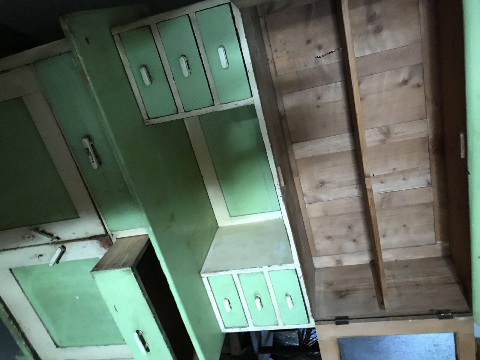 Vintage wooden kitchen cupboard painted green and beige, with glass doors - 1930s
