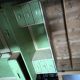 Vintage wooden kitchen cupboard painted green and beige, with glass doors - 1930s