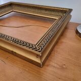 Frame with channels in wood and gilded stucco