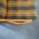 Vintage armchair in bamboo and rattan with a tartan pattern.
