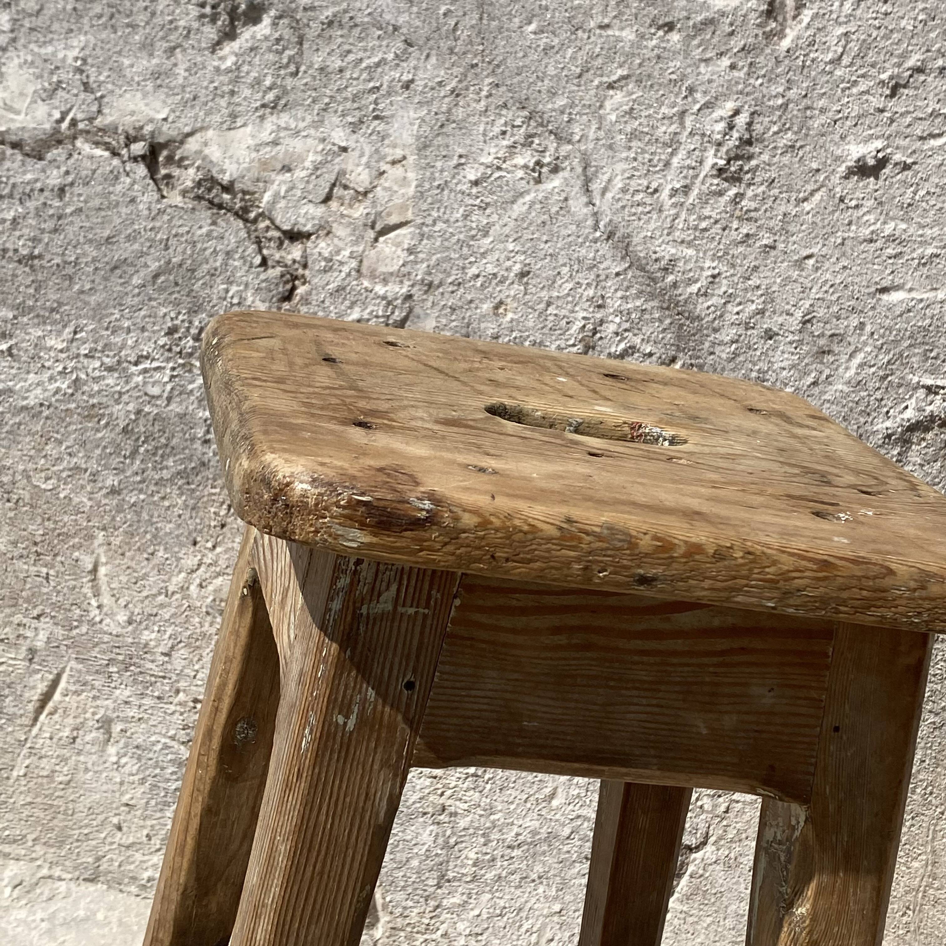 Pair of vintage wooden workshop stools with a patina.