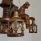 French vintage Breton chandelier with hand-carved figures, well, and lantern lights.