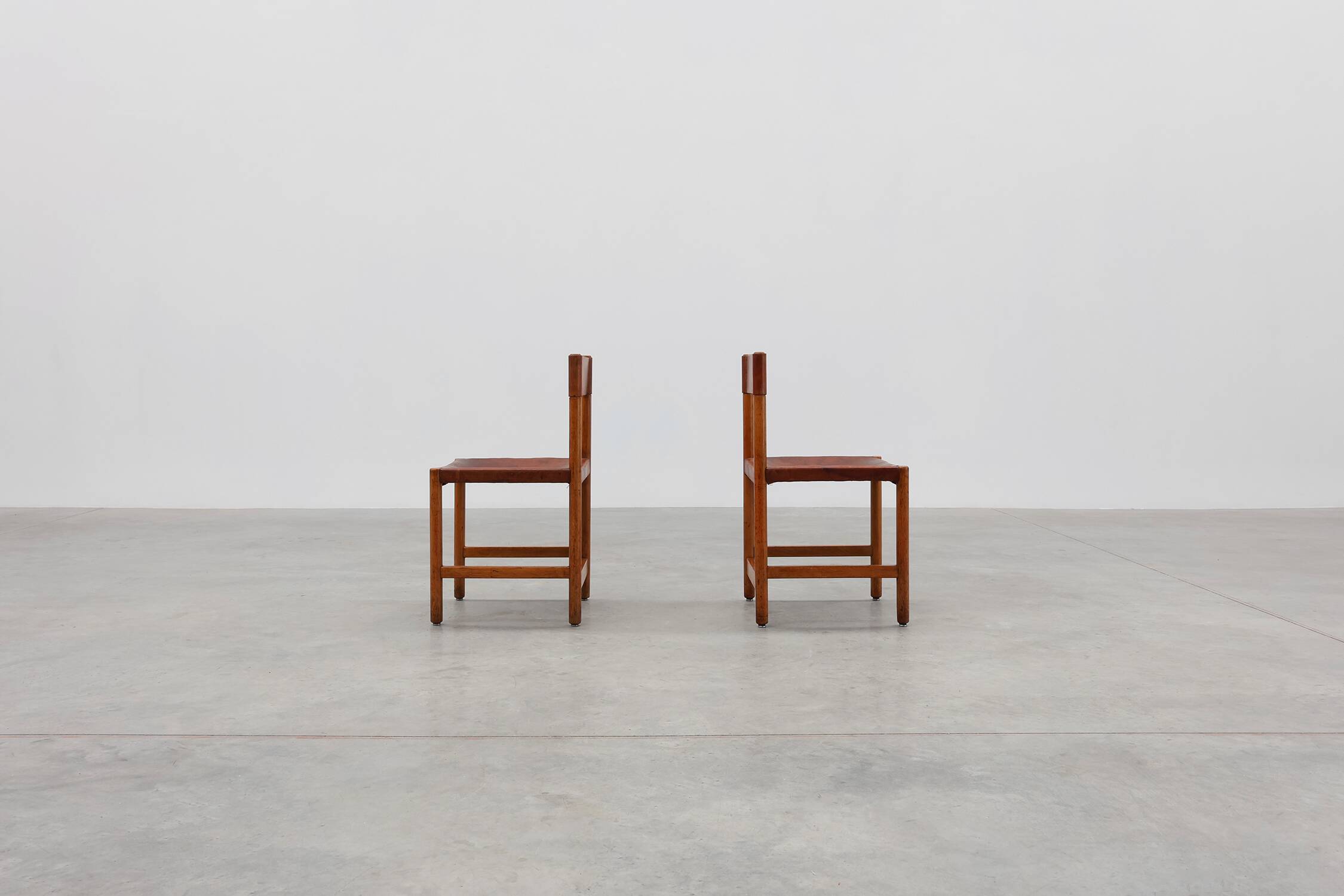 Pair of wood and leather Spanish chairs by Jordi Vilanova, ca. 1960
