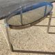Table basse elliptique vers 1970 en métal chromé et verre fumé