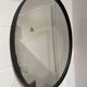Round mirror 75cm in diameter with a black frame.