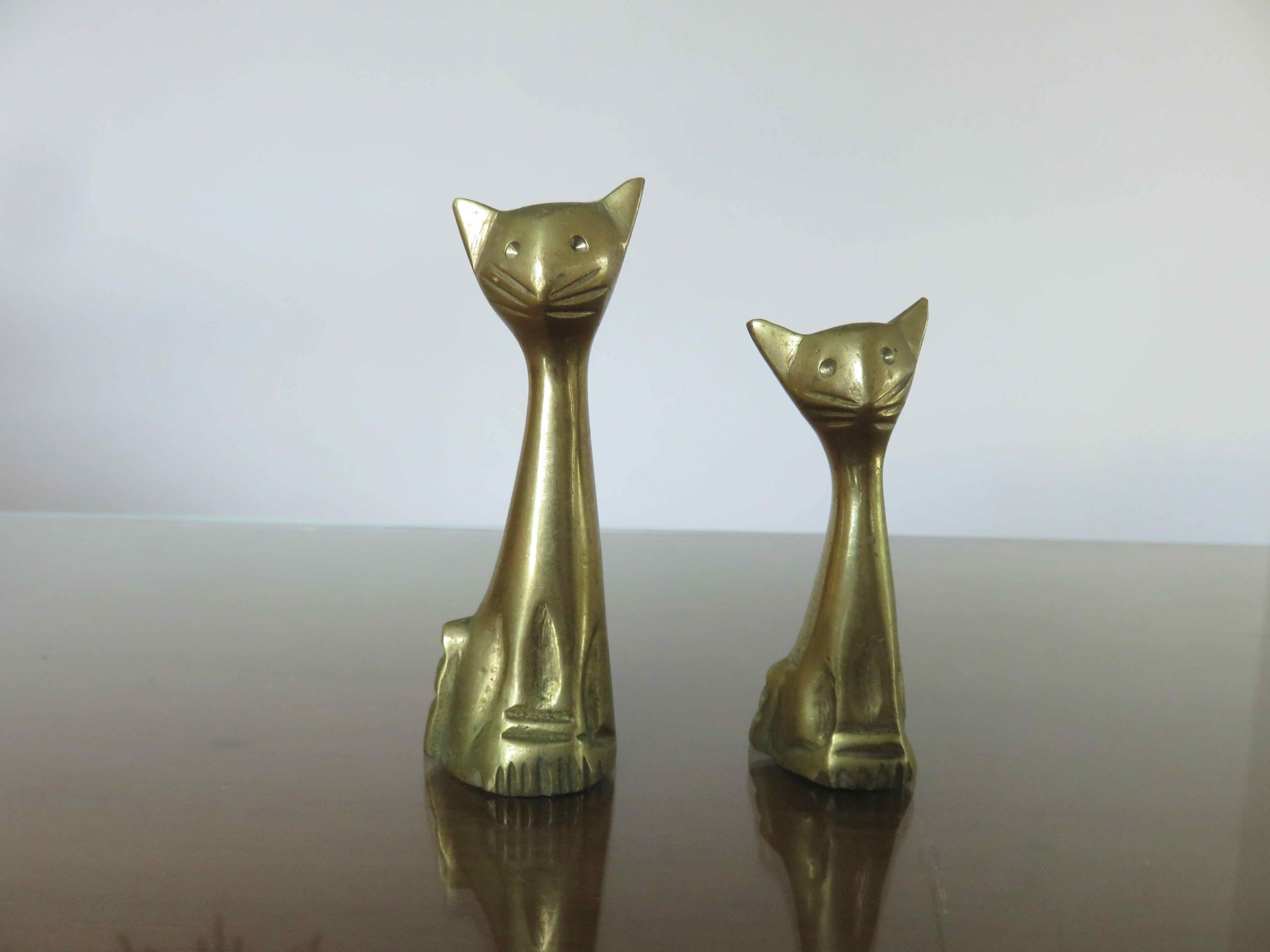 Couple of stylized cats in brass 70s