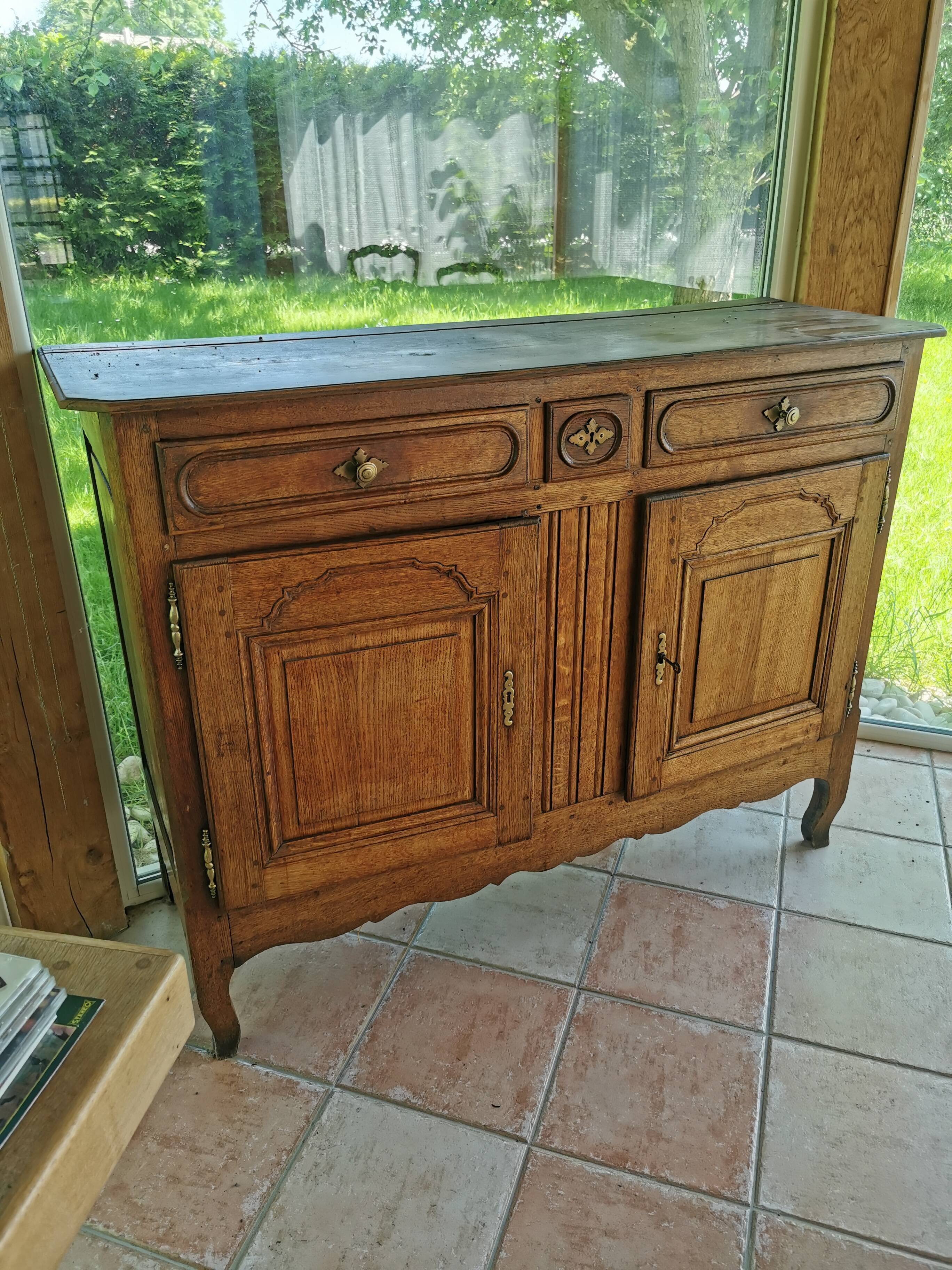 Old low buffet, 19th in rustic solid oak, carved and molded