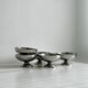 5 silver metal cups.