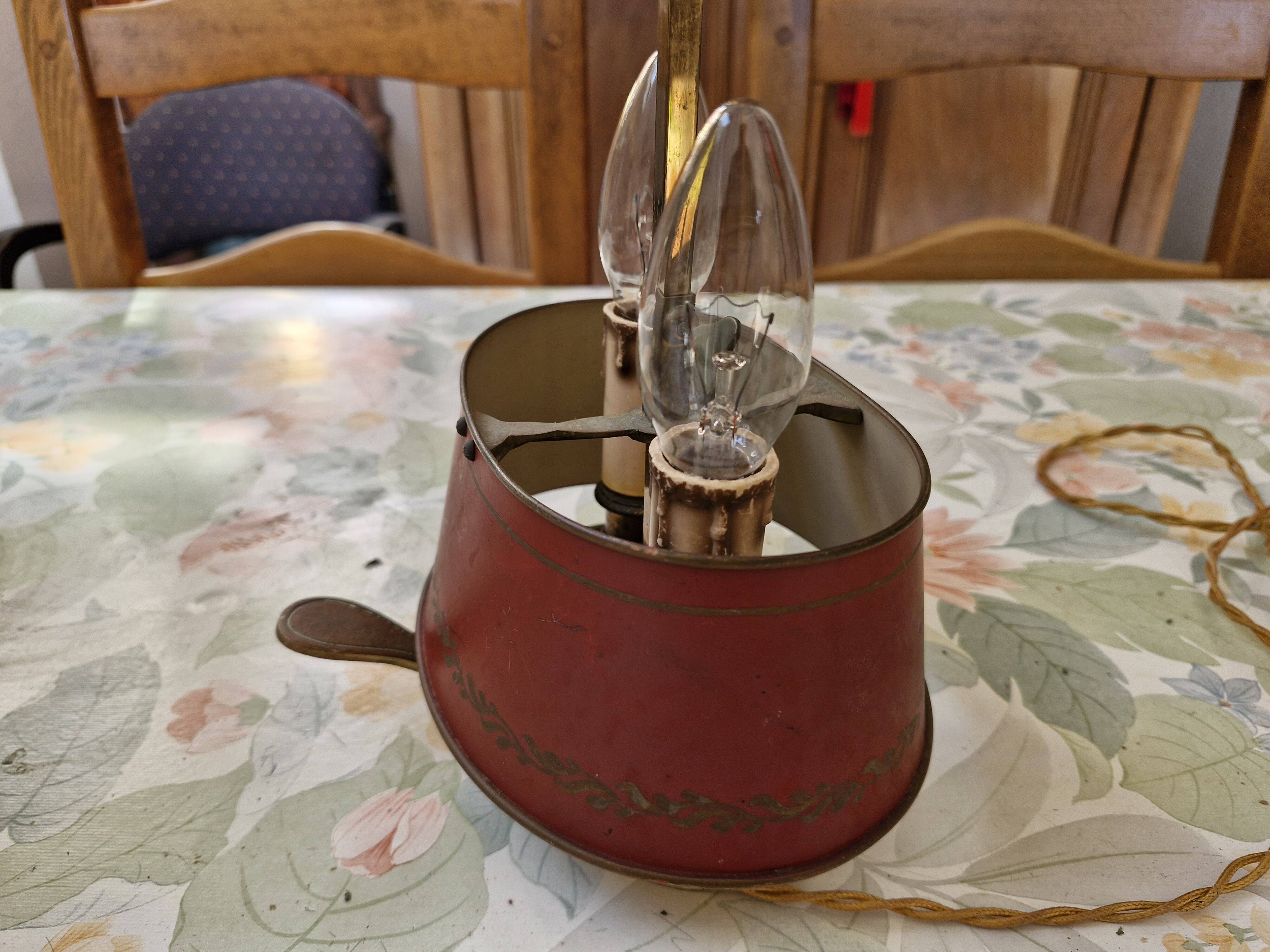 Old silver-plated bronze lamp, except for the arms which are not silver.