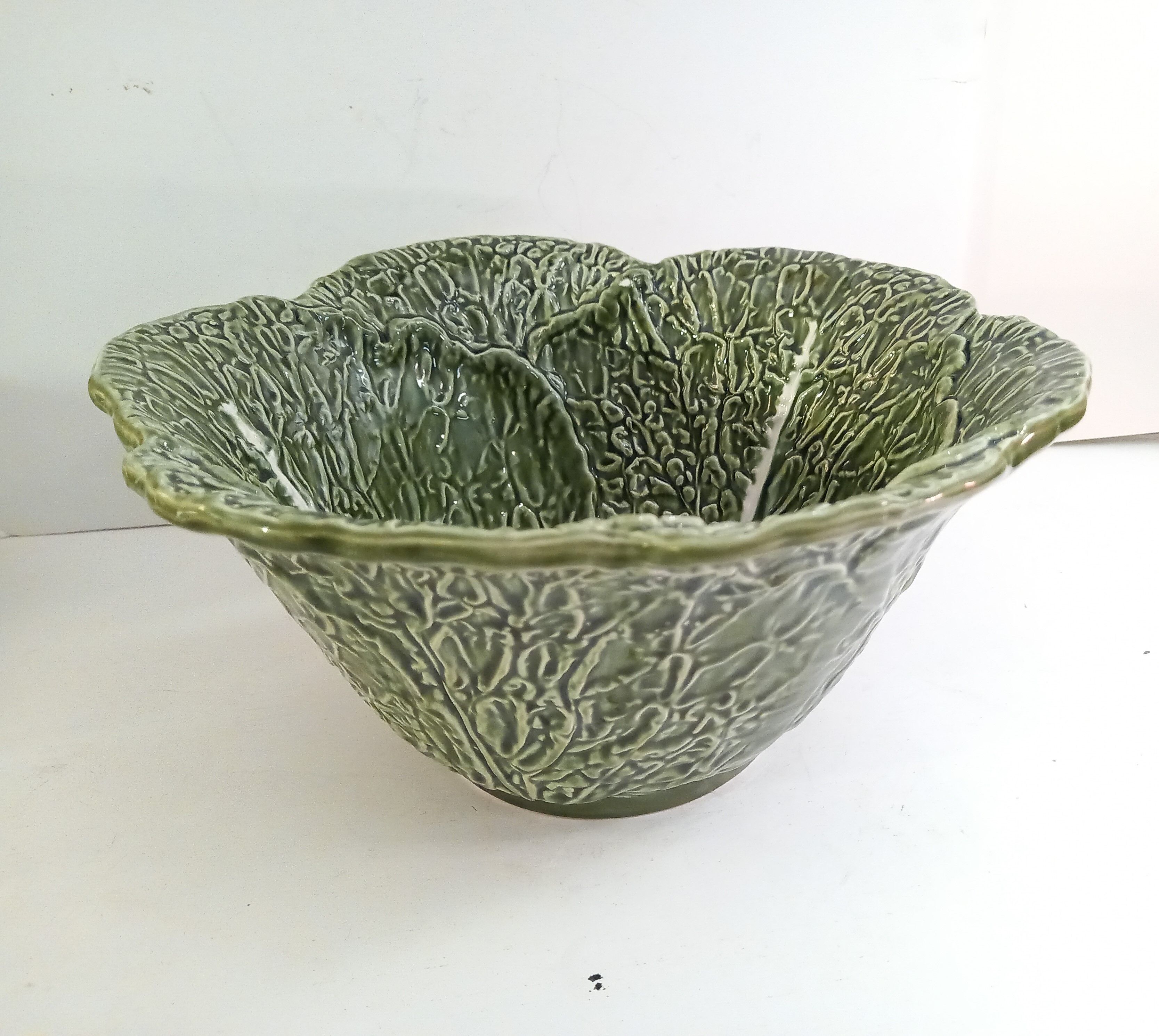 Vintage salad bowl in dabbling cabbage leaf and cutlery