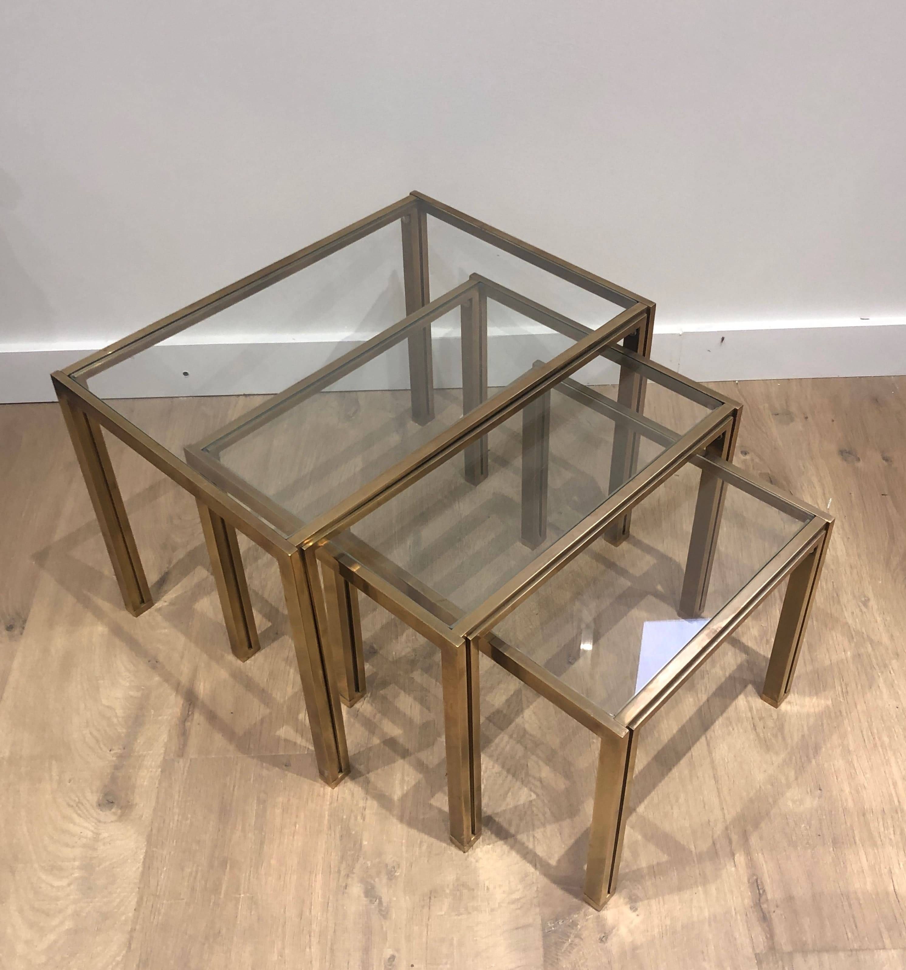Set of 3 nesting tables in brass and glass. French work by Guy Lef.