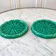 Duo of green slip bottle coasters signed marjac bauzil 50s