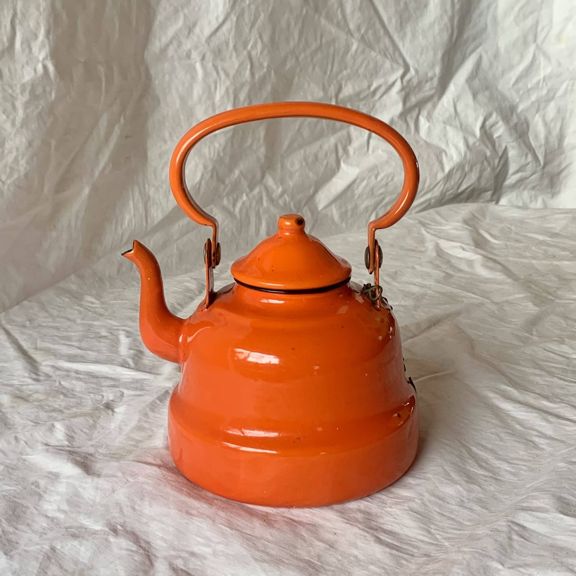Vintage orange enameled sheet metal kettle