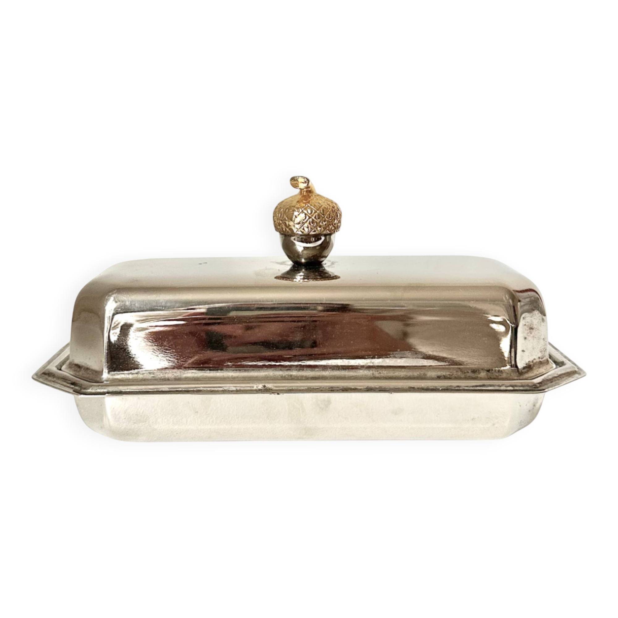 Silver-plated butter dish with a hazelnut knob.