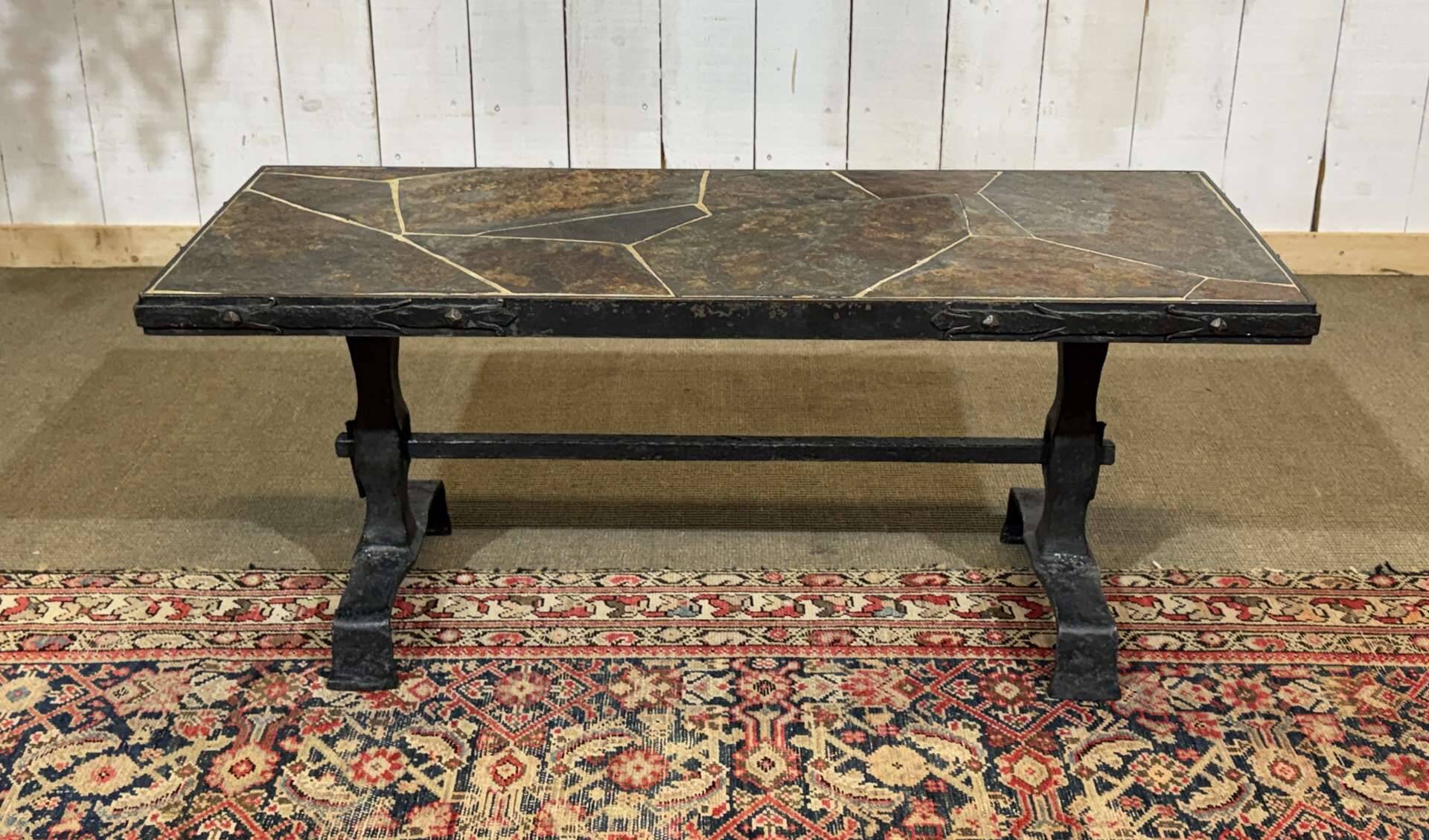 Coffee table in wrought iron with a slate top, work from the 1950s.